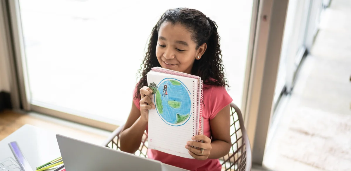 little girl showing a map in the notebook