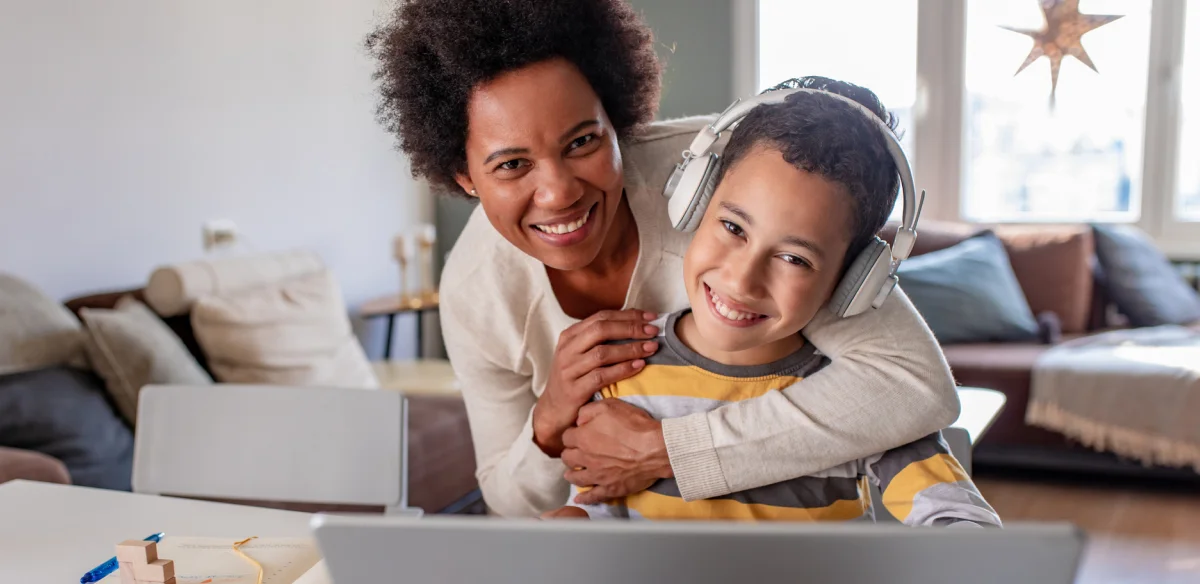 Mother and son hugging at teach other