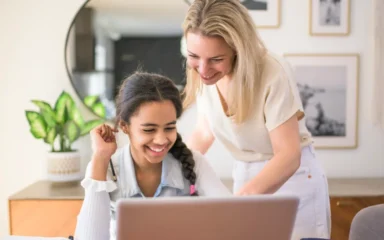 mom and girl looking the computer
