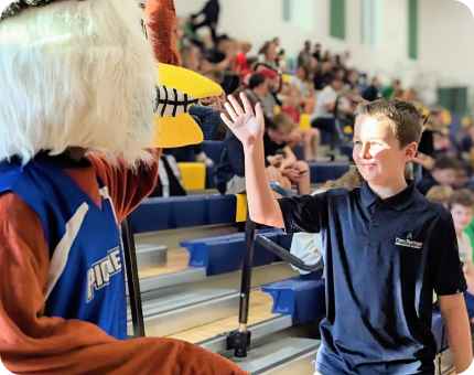 kid smiling with team pet